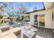 Outdoor living area with a pool, lounge chairs, modern decking, and backyard seating at 5744 150Th N Ave, Clearwater, FL 33760