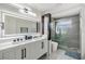 Modern bathroom features a double vanity, glass shower, and stylish fixtures at 5744 150Th N Ave, Clearwater, FL 33760
