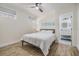 Cozy bedroom with natural light, wood-look tile floors, and coastal-themed decor at 5744 150Th N Ave, Clearwater, FL 33760