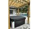 Backyard hot tub beneath a wooden pergola with a view of the swimming pool in the background at 5744 150Th N Ave, Clearwater, FL 33760