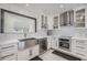 Bright kitchen features white cabinets, stainless steel appliances, subway tile, and a stainless steel farmhouse sink at 5744 150Th N Ave, Clearwater, FL 33760