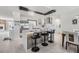 Modern kitchen featuring an island with seating, stainless steel appliances, and sleek white cabinetry at 5744 150Th N Ave, Clearwater, FL 33760