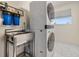 Functional laundry room with a stainless steel sink and a modern washer and dryer at 5744 150Th N Ave, Clearwater, FL 33760