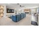 Bright living room features a blue sofa, tiled floors, a ceiling fan, and a gorgeous stone fireplace at 5744 150Th N Ave, Clearwater, FL 33760