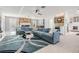 Spacious living room with a stone fireplace, modern lighting, and a wet bar at 5744 150Th N Ave, Clearwater, FL 33760