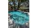 Sparkling pool with clear blue water, lush landscaping, and a tranquil water feature at 5744 150Th N Ave, Clearwater, FL 33760