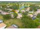 Aerial view of a home in a tranquil community with lush greenery and a scenic lake at 5812 Garden Lakes Majestic, Bradenton, FL 34203