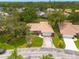 Desirable home with tile roof nestled amongst mature trees and lush landscaping offering privacy and shade at 5812 Garden Lakes Majestic, Bradenton, FL 34203
