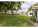 A view of the backyard, showcasing the well-maintained lawn and the exterior of neighboring homes at 5812 Garden Lakes Majestic, Bradenton, FL 34203