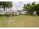 A view of the backyard, showcasing the well-maintained lawn and the home's exterior at 5812 Garden Lakes Majestic, Bradenton, FL 34203