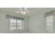 This bedroom includes a ceiling fan and a window offering a view of the home's exterior at 5812 Garden Lakes Majestic, Bradenton, FL 34203
