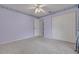 This carpeted bedroom features a ceiling fan, patterned wall trim, and a spacious closet at 5812 Garden Lakes Majestic, Bradenton, FL 34203