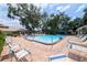 A relaxing community pool with ample lounge chairs and landscaped surroundings at 5812 Garden Lakes Majestic, Bradenton, FL 34203