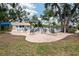Outdoor patio area features tables and chairs near the community pool and clubhouse for residents at 5812 Garden Lakes Majestic, Bradenton, FL 34203
