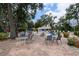 Outdoor patio area features plenty of tables and chairs near the community pool, perfect for residents at 5812 Garden Lakes Majestic, Bradenton, FL 34203