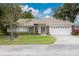 Charming single-story home featuring a tile roof, well-maintained lawn, and an attached two-car garage at 5812 Garden Lakes Majestic, Bradenton, FL 34203
