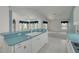 View from kitchen sink out to the living room with tile floors and plenty of natural light at 5812 Garden Lakes Majestic, Bradenton, FL 34203
