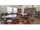 Cozy library with bookshelves filled with books and tables for reading or studying at 5812 Garden Lakes Majestic, Bradenton, FL 34203