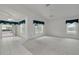 Large living area featuring tile flooring, high ceilings, and access to the screened patio at 5812 Garden Lakes Majestic, Bradenton, FL 34203