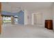 Large living room with a ceiling fan, sliding glass doors leading to the lanai, and adjacent doorways at 5812 Garden Lakes Majestic, Bradenton, FL 34203