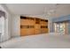 Spacious living room boasts a built-in wooden cabinet and a ceiling fan, perfect for entertaining at 5812 Garden Lakes Majestic, Bradenton, FL 34203