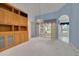 Bright living room with custom built-ins, vaulted ceiling, and sliding glass doors to screened patio at 5812 Garden Lakes Majestic, Bradenton, FL 34203