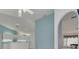 View from living room into kitchen with vaulted ceilings, skylights, and arched doorway at 5812 Garden Lakes Majestic, Bradenton, FL 34203