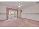 Main bedroom features carpeted floors, ample natural light, and access to the enclosed patio at 5812 Garden Lakes Majestic, Bradenton, FL 34203
