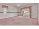 Carpeted main bedroom with an ensuite bathroom, patio access, and large windows at 5812 Garden Lakes Majestic, Bradenton, FL 34203