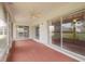 Spacious enclosed patio with ceiling fan and sliding glass doors, providing backyard views at 5812 Garden Lakes Majestic, Bradenton, FL 34203