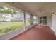 Enclosed patio with ceiling fan and a view of the well-maintained lawn and surrounding neighborhood at 5812 Garden Lakes Majestic, Bradenton, FL 34203
