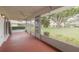 Enclosed patio features a ceiling fan, seating area, and views of the landscaped backyard at 5812 Garden Lakes Majestic, Bradenton, FL 34203