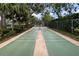 Outdoor shuffleboard court surrounded by lush landscaping, offering a recreational amenity at 5812 Garden Lakes Majestic, Bradenton, FL 34203