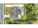 Aerial view of home showcasing its well-manicured yard and screened-in lanai with pool and hot tub at 5905 Berkford Dr, Holiday, FL 34690
