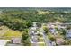 An aerial view shows a lush neighborhood with mature trees, well-kept homes, and inviting swimming pools at 5905 Berkford Dr, Holiday, FL 34690