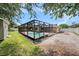 Backyard showcasing pool, hot tub, storage shed and screened-in lanai at 5905 Berkford Dr, Holiday, FL 34690