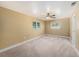 Bedroom with a ceiling fan, neutral carpet, and bright windows at 5905 Berkford Dr, Holiday, FL 34690