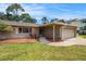 Single-story home with a two-car garage, front lawn, and landscaping at 5905 Berkford Dr, Holiday, FL 34690