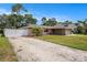 Property featuring front lawn, driveway, and a white fence at 5905 Berkford Dr, Holiday, FL 34690