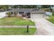 An attractive single-story home features a well-manicured lawn and a spacious driveway at 5905 Berkford Dr, Holiday, FL 34690