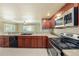 Kitchen features stainless steel appliances, plenty of cabinets, and views to the living space at 5905 Berkford Dr, Holiday, FL 34690