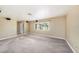 Spacious living room with neutral carpet and ample natural light at 5905 Berkford Dr, Holiday, FL 34690