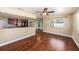 Open-concept living room featuring hardwood floors, a ceiling fan, and views of the kitchen and beyond at 5905 Berkford Dr, Holiday, FL 34690