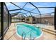 Gorgeous kidney-shaped pool with spa, in a screened enclosure, perfect for relaxation and entertaining at 5905 Berkford Dr, Holiday, FL 34690