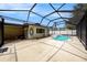 View of screened in pool with hot tub and covered lanai area with access to the home's interior at 5905 Berkford Dr, Holiday, FL 34690