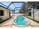 Sparkling pool with ample deck space, hot tub, and screened enclosure for year-round enjoyment at 5905 Berkford Dr, Holiday, FL 34690