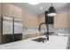 Close-up of a modern kitchen island with marble countertops, stainless steel appliances, and stylish light fixtures at 607 W Euclid Ave # 3, Tampa, FL 33602