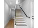 Bright entryway features a modern staircase with light wood treads and a sleek black handrail at 607 W Euclid Ave # 3, Tampa, FL 33602