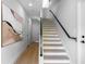 Bright stairway features modern design with light wood floors and black handrail at 607 W Euclid Ave # 3, Tampa, FL 33602
