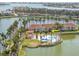 An aerial view of condo community with pool, palm trees, and a lake in the background at 6100 Bahia Del Mar Cir # 105, St Petersburg, FL 33715